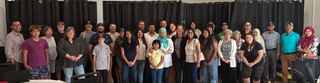A large, diverse group of neighbours gathered together at a community event in support of Bashir Ahmmed.